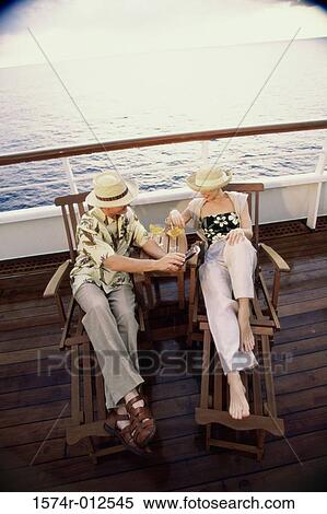High angle view of a young couple sitting in deck chairs on a cruise ship View Large Photo Image Stock Photography - High angle view of a young couple sitting in deck chairs on a cruise ship. Fotosearch