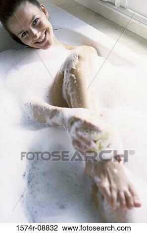 High angle view of a young woman bathing View Large Photo Image Stock Image - High angle view of a young woman bathing. Fotosearch