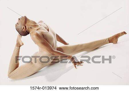 High angle view of a young woman stretching her legs View Large Photo Image Picture - High angle view of a young woman stretching her legs. Fotosearch