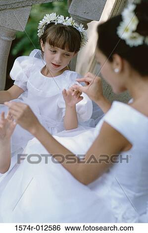 High angle view of a young woman playing with a flower girl View Large Photo Image Stock Photograph - High angle view of a young woman playing with a flower girl. Fotosearch