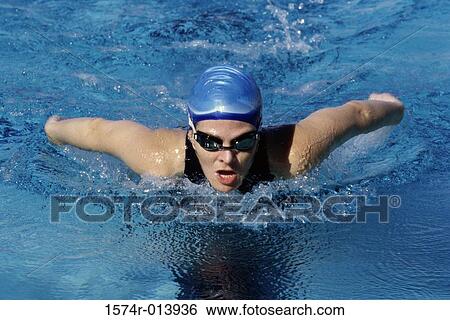 High angle view of a young woman swimming in a swimming pool View Large Photo Image Stock Photograph - High angle view of a young woman swimming in a swimming pool. Fotosearch