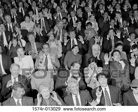 Stock Photo - High angle view of audience looking surprised. Fotosearch