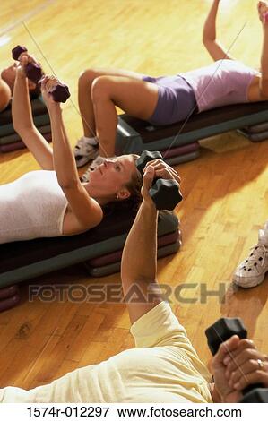 Stock Photo - High angle view of five people exercising in a step aerobics class. Fotosearch