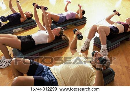 Stock Photo - High angle view of five people exercising in a step aerobics class. Fotosearch