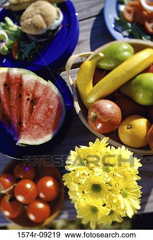 High angle view of flowers and food on a picnic table View Large Photo Image Stock Photo - High angle view of flowers and food on a picnic table. Fotosearch