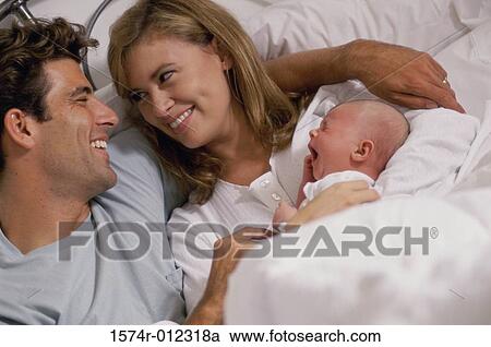 High angle view of parents and their son on the bed View Large Photo Image Stock Image - High angle view of parents and their son on the bed. Fotosearch