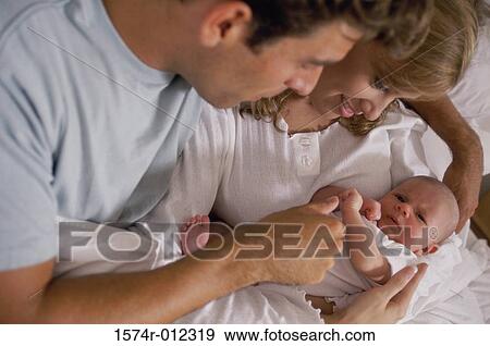 Stock Photo - High angle view of parents looking at their son. Fotosearch