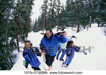 Stock Image - High angle view of parents pulling their children on an inflatable ring. Fotosearch