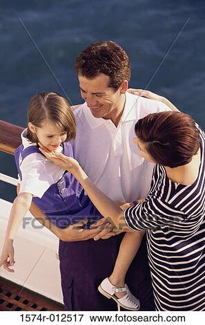 High angle view of parents standing with their daughter on the deck of a cruise ship View Large Photo Image Stock Photo - High angle view of parents standing with their daughter on the deck of a cruise ship. Fotosearch