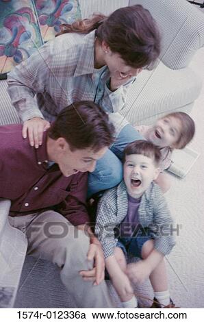 Stock Image - High angle view of parents with their son and daughter laughing. Fotosearch