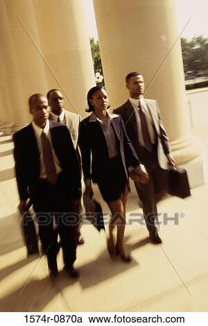 High angle view of three businessmen and a businesswoman walking together View Large Photo Image Stock Image - High angle view of three businessmen and a businesswoman walking together. Fotosearch