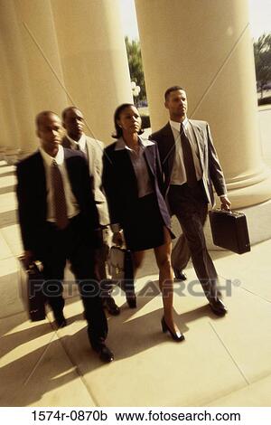 High angle view of three businessmen and a businesswoman walking together View Large Photo Image Stock Image - High angle view of three businessmen and a businesswoman walking together. Fotosearch