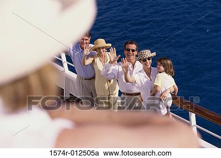 High angle view of two mid adult couples with a girl standing on the deck of a cruise ship waving View Large Photo Image Stock Image - High angle view of two mid adult couples with a girl standing on the deck of a cruise ship waving. Fotosearch