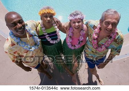 Stock Image - High angle view of two senior couples standing together. Fotosearch
