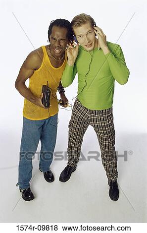 Stock Photo - High angle view of two young men wearing headphones. Fotosearch
