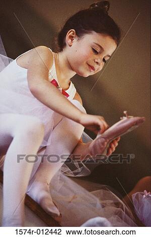 Stock Image - Low angle view of a ballerina wearing ballet slippers. Fotosearch