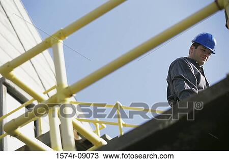 Low angle view of a construction worker View Large Photo Image Stock Image - Low angle view of a construction worker. Fotosearch