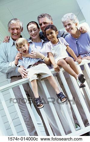 Stock Image - Low angle view of a family near a banister. Fotosearch