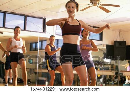 Low angle view of a four people doing step aerobics in a gym View Large Photo Image Stock Image - Low angle view of a four people doing step aerobics in a gym. Fotosearch