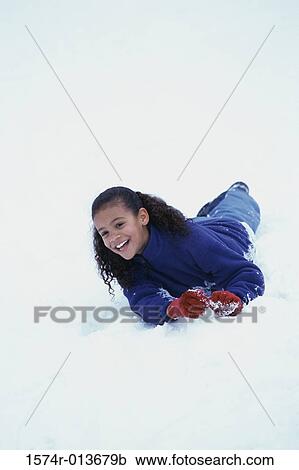 Low angle view of a girl lying down on snow View Large Photo Image Stock Image - Low angle view of a girl lying down on snow. Fotosearch