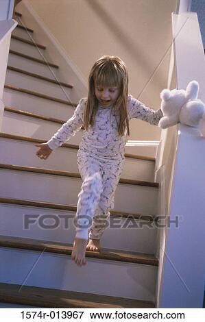 Low angle view of a girl walking down stairs View Large Photo Image Stock Photo - Low angle view of a girl walking down stairs. Fotosearch