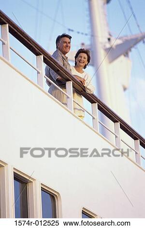 Low angle view of a mature couple standing on the deck of a cruise ship View Large Photo Image Stock Photography - Low angle view of a mature couple standing on the deck of a cruise ship. Fotosearch