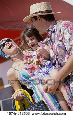 Low angle view of a mid adult couple laughing with their daughter View Large Photo Image Stock Image - Low angle view of a mid adult couple laughing with their daughter. Fotosearch