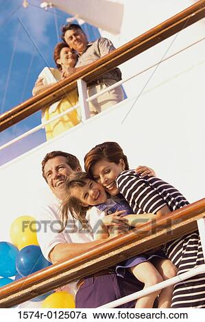 Low angle view of a mid adult couple with their daughter standing on the deck of a cruise ship laughing View Large Photo Image Stock Image - Low angle view of a mid adult couple with their daughter standing on the deck of a cruise ship laughing. Fotosearch