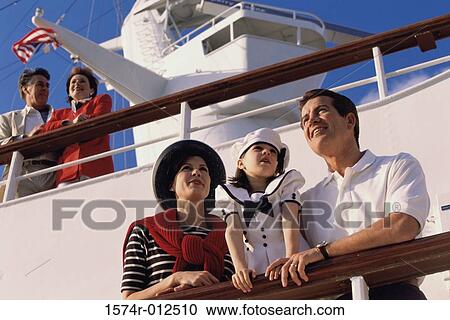 Low angle view of a mid adult couple with their daughter standing on the deck of a cruise ship View Large Photo Image Stock Image - Low angle view of a mid adult couple with their daughter standing on the deck of a cruise ship. Fotosearch