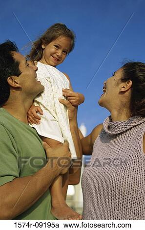 Low angle view of a mother and father with their daughter View Large Photo Image Stock Image - Low angle view of a mother and father with their daughter. Fotosearch