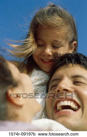 Low angle view of a mother and father with their daughter View Large Photo Image Stock Image - Low angle view of a mother and father with their daughter. Fotosearch