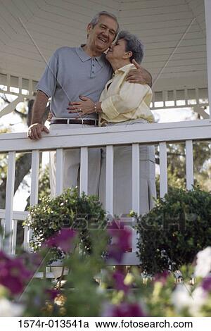 Stock Image - Low angle view of a senior woman kissing a senior man. Fotosearch