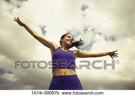 Low angle view of a young woman exercising View Large Photo Image Stock Image - Low angle view of a young woman exercising. Fotosearch