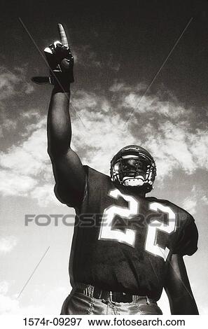 Low angle view of an American football player pointing up View Large Photo Image Stock Photo - Low angle view of an American football player pointing up. Fotosearch
