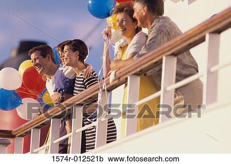 Low angle view of five people standing on the deck of a cruise ship View Large Photo Image Stock Image - Low angle view of five people standing on the deck of a cruise ship. Fotosearch