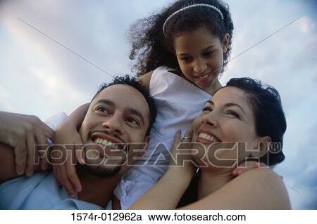 Low angle view of parents carrying their daughter View Large Photo Image Stock Image - Low angle view of parents carrying their daughter. Fotosearch