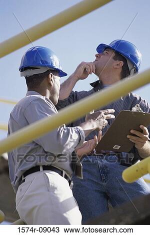 Low angle view of two construction workers View Large Photo Image Stock Image - Low angle view of two construction workers. Fotosearch