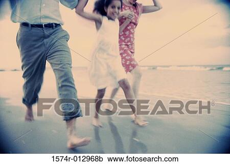 Low section view of a couple on the beach with their daughter View Large Photo Image Stock Image - Low section view of a couple on the beach with their daughter. Fotosearch