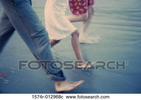 Low section view of a couple on the beach with their daughter View Large Photo Image Stock Image - Low section view of a couple on the beach with their daughter. Fotosearch