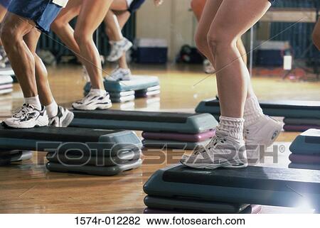 Low section view of five people doing step aerobics in a gym View Large Photo Image Stock Image - Low section view of five people doing step aerobics in a gym. Fotosearch