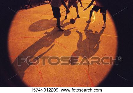 Low section view of three men playing basketball View Large Photo Image Stock Photo - Low section view of three men playing basketball. Fotosearch