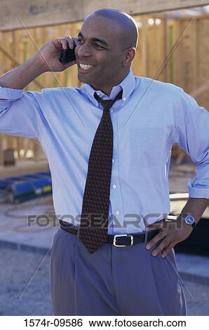 Male architect talking on a mobile phone View Large Photo Image Stock Photograph - Male architect talking on a mobile phone. Fotosearch