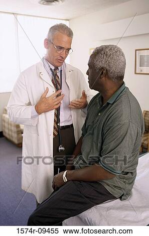 Male doctor talking to a male patient View Large Photo Image Stock Photography - Male doctor talking to a male patient. Fotosearch