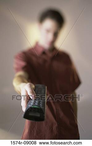 Man holding a remote control View Large Photo Image Stock Photo - Man holding a remote control. Fotosearch