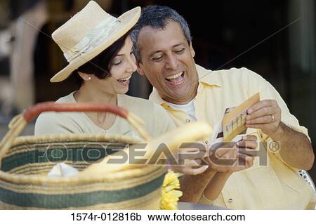 Mature couple choosing postcards View Large Photo Image Stock Image - Mature couple choosing postcards. Fotosearch