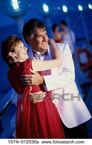 Stock Image - Mature couple dancing on the deck of a cruise ship. Fotosearch
