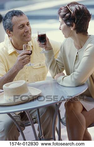 Mature couple holding wineglasses View Large Photo Image Stock Image - Mature couple holding wineglasses. Fotosearch
