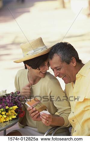 Mature couple looking at postcards View Large Photo Image Stock Image - Mature couple looking at postcards. Fotosearch