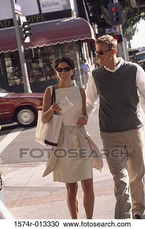 Stock Image - Mature couple walking on the sidewalk. Fotosearch