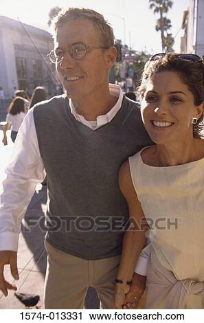 Stock Image - Mature couple walking on the sidewalk. Fotosearch